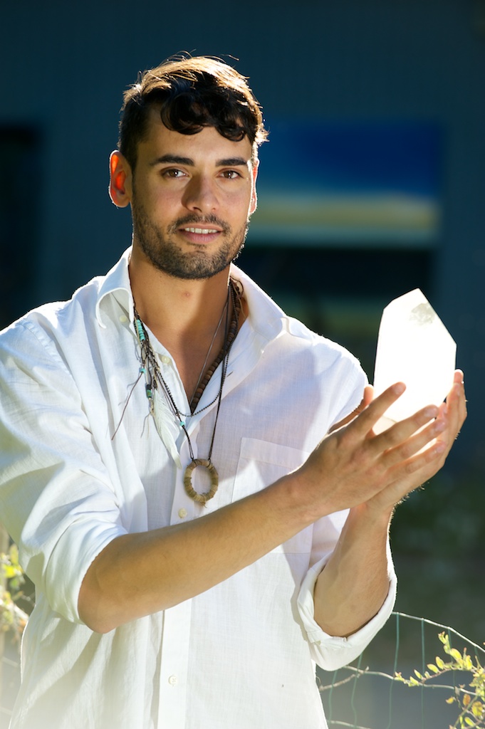 John Corsa, crystal healer, holding clear Quartz crystal